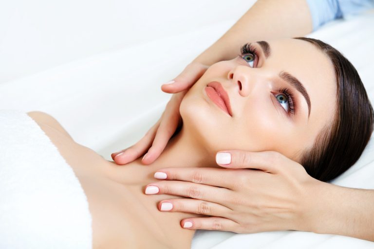 Face Massage. Close-up of a Young Woman Getting Spa Treatment